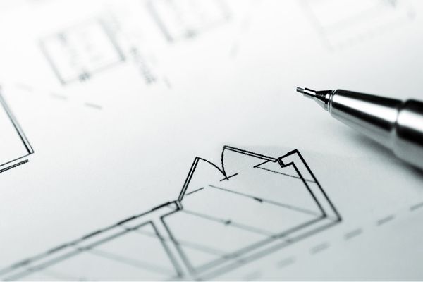 Close-up of a kitchen floor plan and the tip of a mechanical pencil