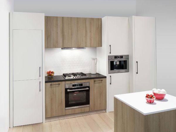 Small functional kitchen in a classic  design with built-in cooking appliances and built-in coffee machine