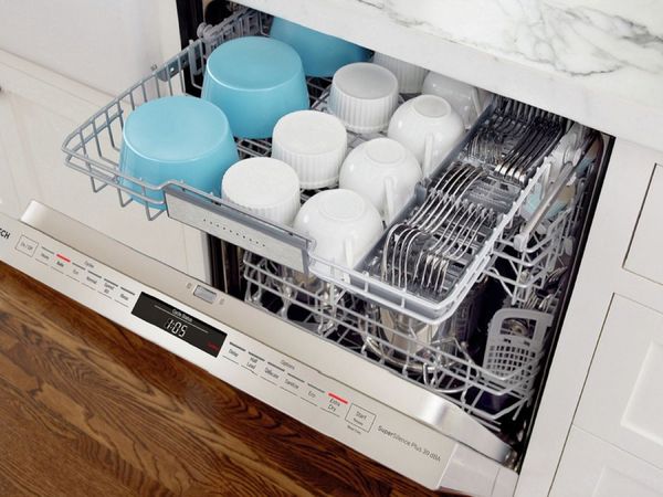 Open dishwasher with extra top rack for cups and silverware