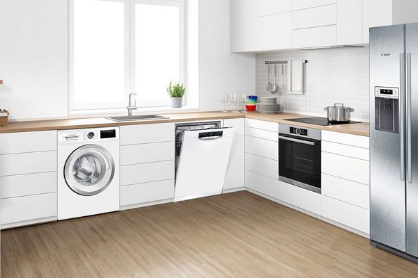White kitchen with numerous appliances installed
