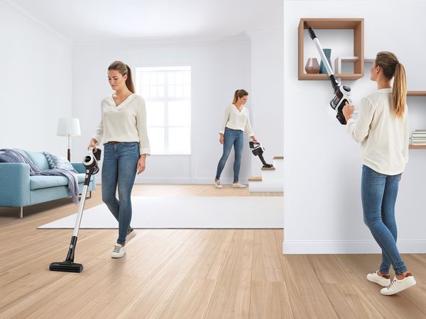 A woman in three different poses, vacuuming different spots.