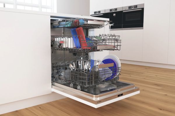 Full Bosch PerfectDry dishwasher with door open and three racks pulled out