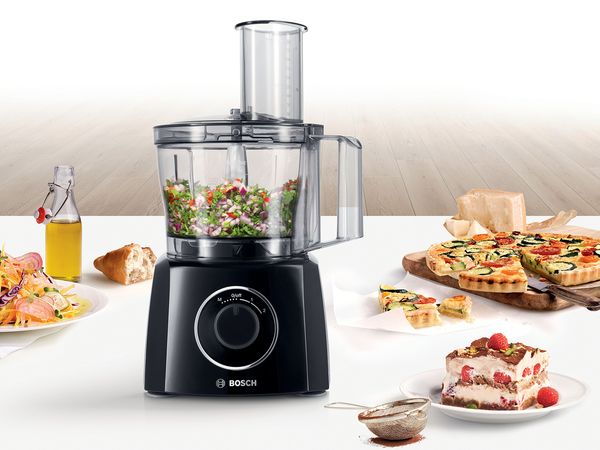 Bosch food processor surrounded by different foods