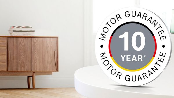The logo for the 10-year motor guarantee on Bosch vacuum cleaners is superimposed over a living area.
