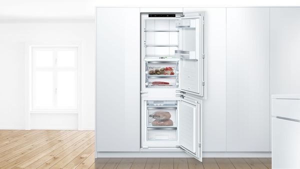 A 60-cm built-in Bosch fridge with open door to show food and drinks inside.