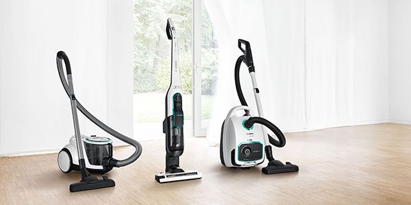 Lineup in bright room of three Bosch ProHygienic vacuums, bagless, cordless and bagged