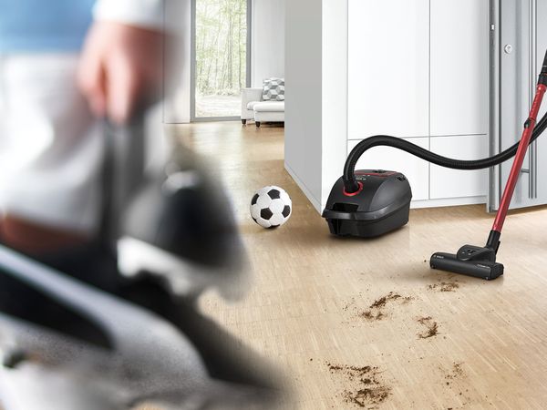 ProPower vacuum in a high-traffic hallway with a soccer ball, shoes and dirt 
