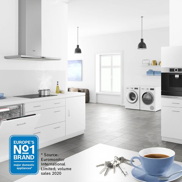 White spacious kitchen with multiple appliances and Europe's No1 logo in corner