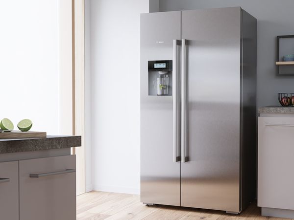 Modern kitchen with silver side-by-side Bosch fridge, suitable for a family.