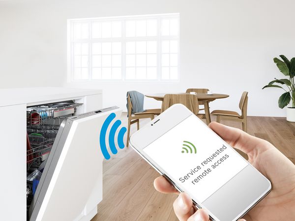 Smartphone met de Home Connect app, en een Bosch oven en koffiemachine in de achtergrond.