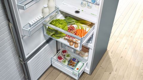 Open fridge with vegetables