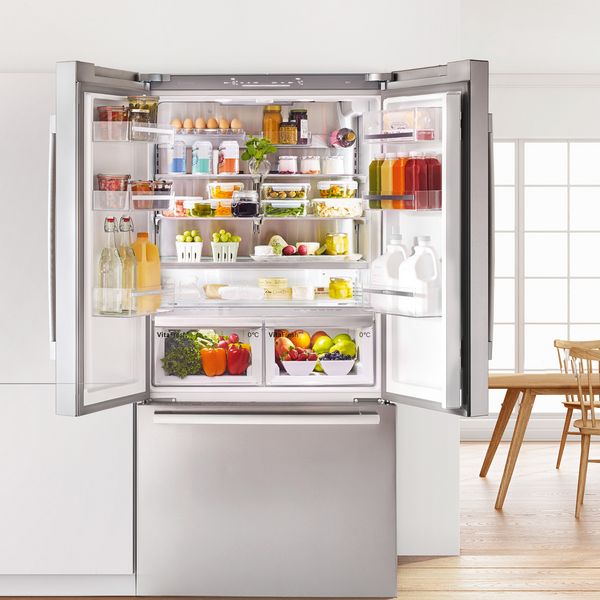 Open fridge with food in a kitchen