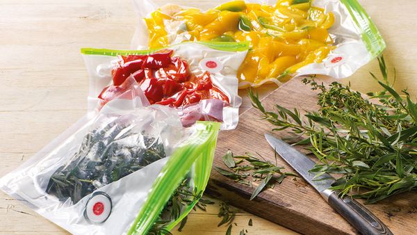Vacuum sealing bags full of different fresh foods to stay fresh for longer.