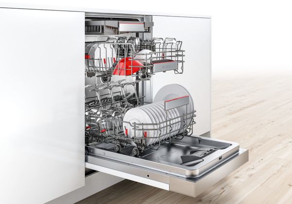 Semi-integrated slimline dishwasher from Bosch with an open door in a stylish kitchen.