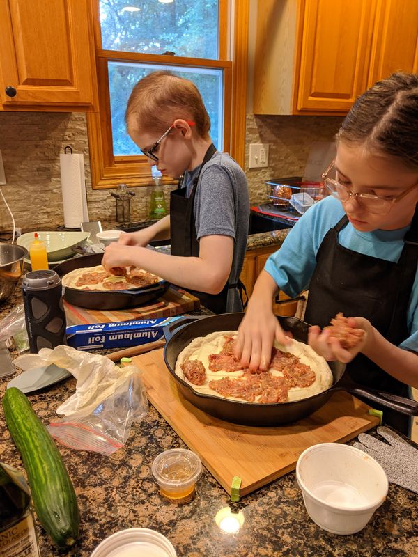 Reed and his sister making pizza