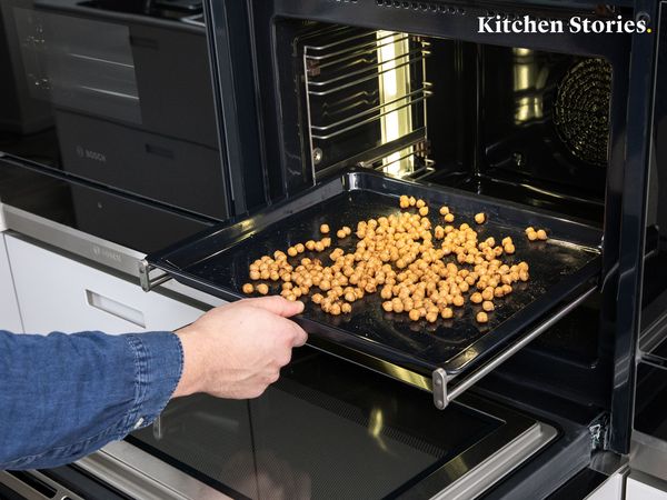 Putting chickpeas into the oven