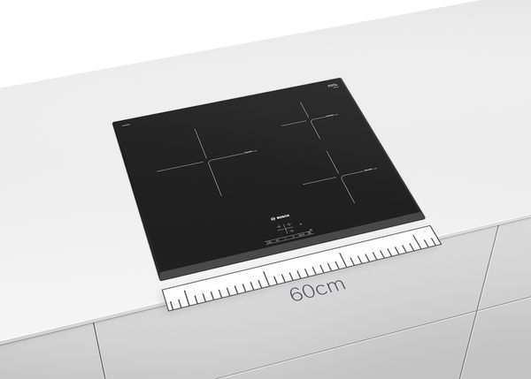 A Bosch 60cm electric hob in black with a blue ruler below illustrating the size.