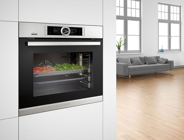 A Bosch steam oven with vegetables inside. 