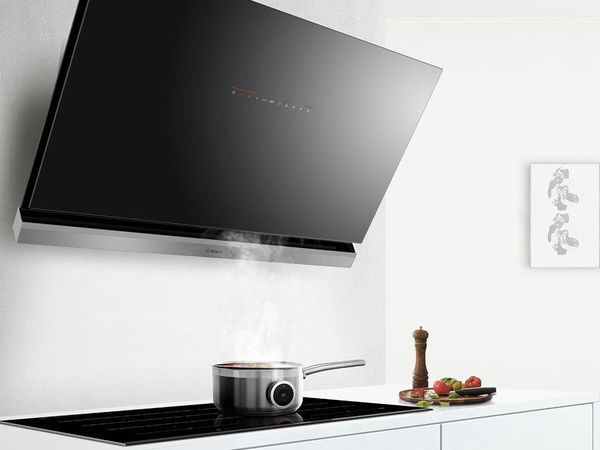 An angled version of a wall-mounted cooker hood.
