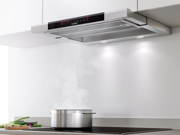 A telescopic cooker hood that's pulled out to use.