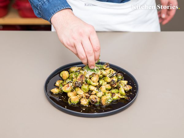 Sprinkling mint over cooked brussels sprouts