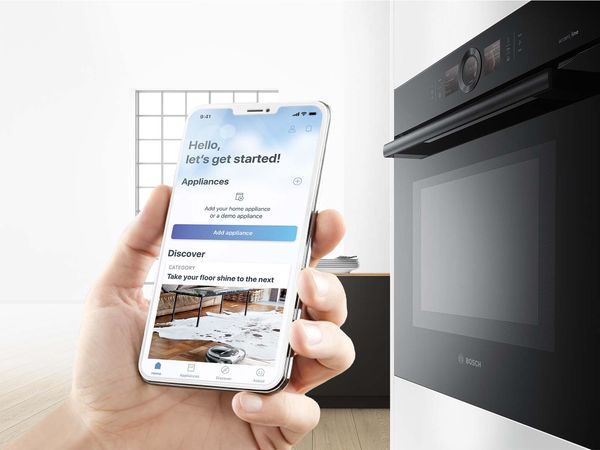 Person using their smartphone to control their Bosch oven.