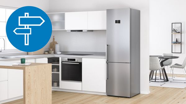 Srebrn prostostoječi hladilnik z zamrzovalnikom Bosch v beli kuhinji.