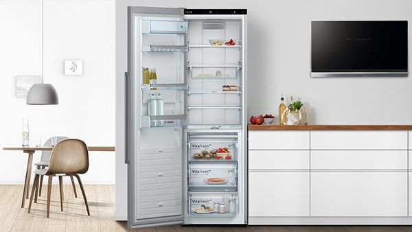 Fridge freezer with doors open in kitchen space