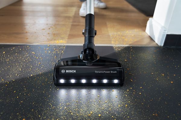 Individual vacuuming a floor, demonstrating effective cleaning techniques.