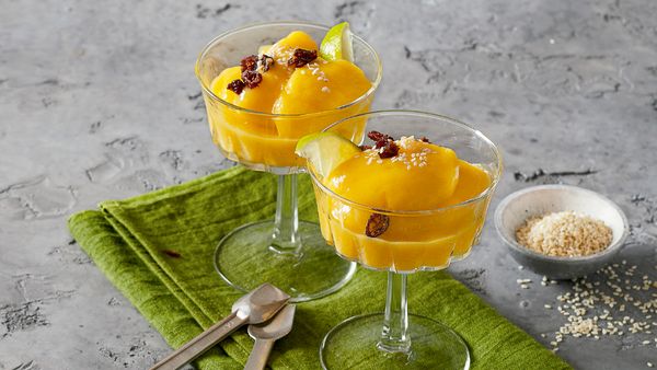 Two small bowls filled with a frozen cream made from mangos.