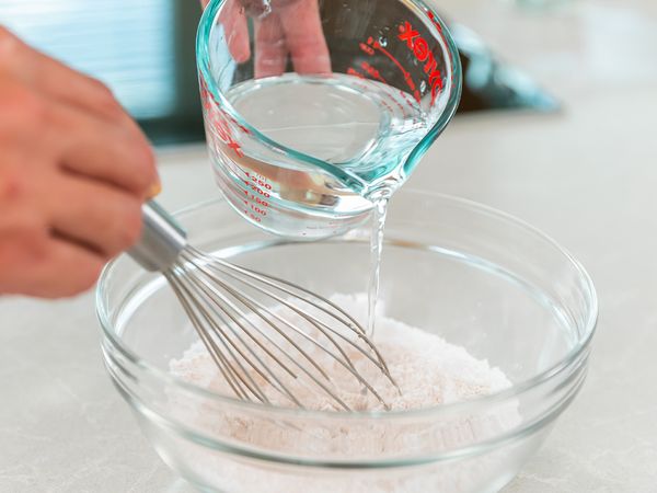 1. In a mixing bowl, add quinoa flour, tapioca flour, salt and mix with a whisk. While whisking, add water, and continue until the batter is well combined.