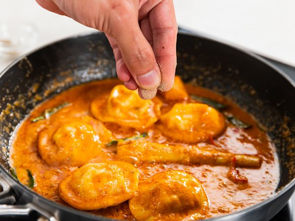 9. Add whipping and coconut cream. Simmer for about 5 minutes. Add Tom Yum paste. Continue frying for about 1 minute. Add pasta water to achieve your desired sauce consistency. Add Ravioli and toss. Season with salt and pepper.