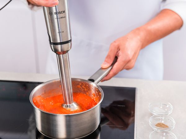 Using your Hand Blender, blend the mixture while simmering