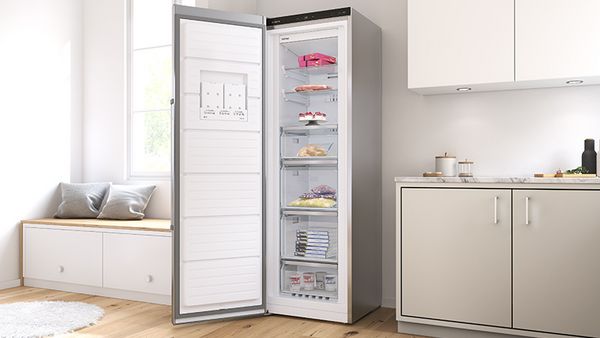 White freestanding Bosch chest freezer in a modern white room.