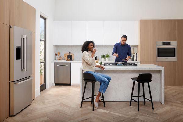 Quiet Mark logo displayed on a wall next to a fruit bowl and a cup, indicating low noise appliances. 