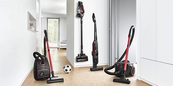 A variety of vacuum cleaners in a hallway