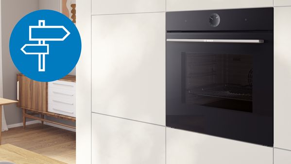 A black oven with a blue arrow pointing to it, indicating its location or highlighting its presence.