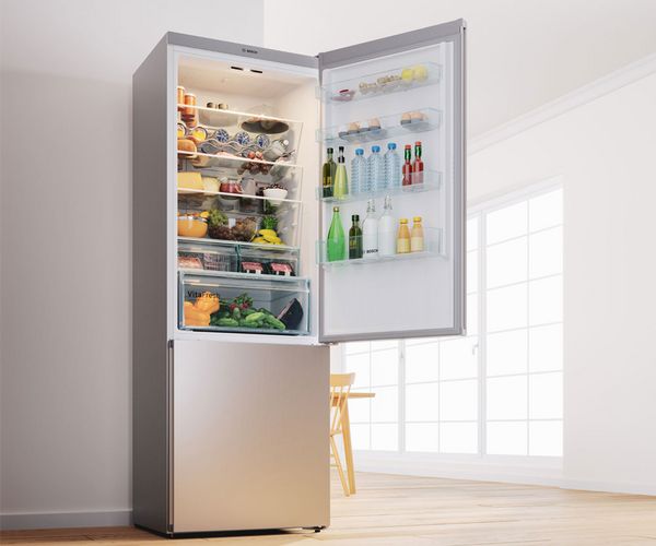 Freestanding stainless steel fridge with top freezer and temperature monitor at eye level