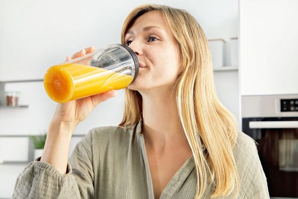 Eine Frau trinkt aus der ToGo-Flasche des Bosch Standmixers VitaPower Serie 4.