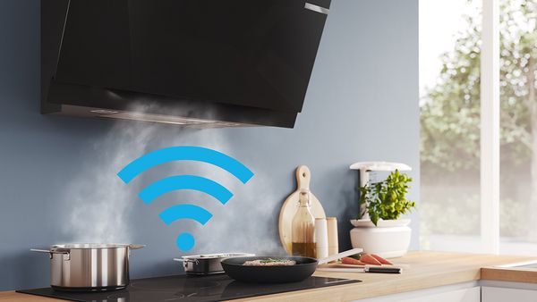 Person using phone to connect hob and hood