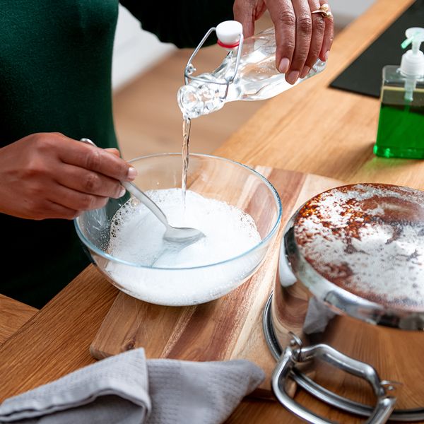 Pouring white vinegar into a bowl