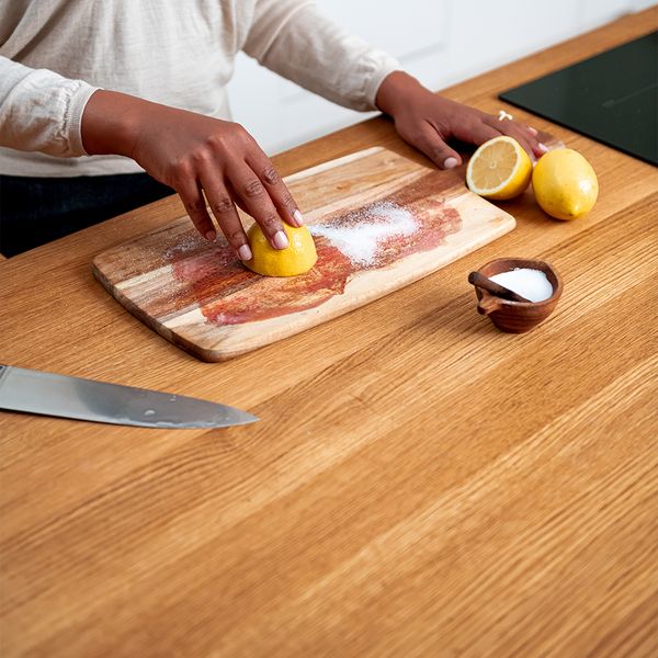 Rubbing lemon into the cutting board of salt
