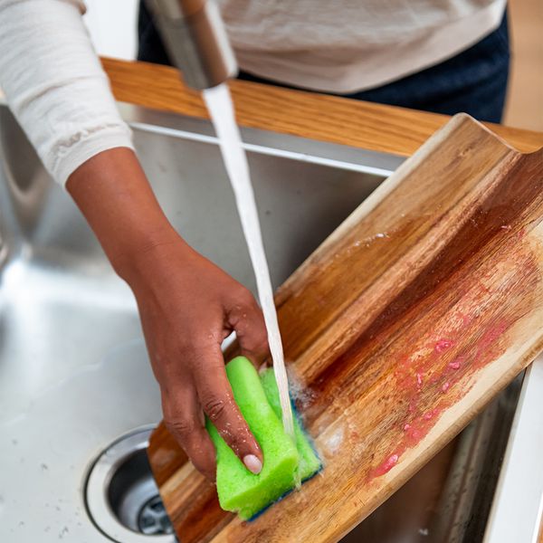 Rinsing off cutting board in sink