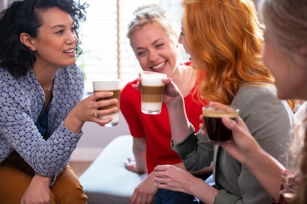 Women talking while drinking different beverages.