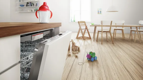 Alexa device that is connected to the dishwasher on top of a table.