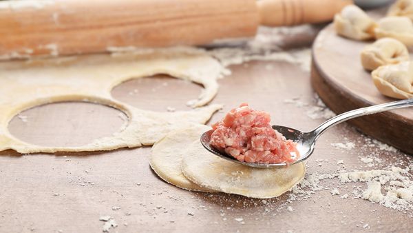 Spoon full of minched meat in the centre of the dumpling