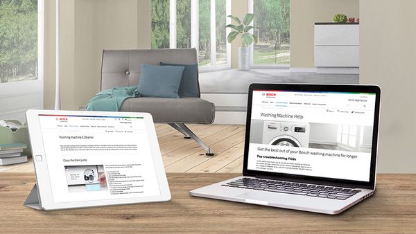 Laptop and tablet on a countertop showing Bosch website