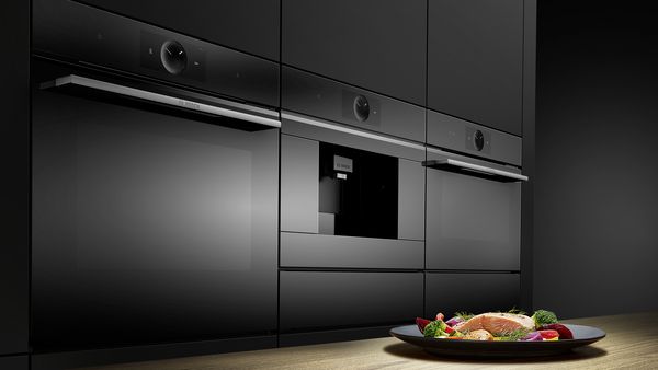 Series 8 oven range in a kitchen. On the counter is a plate with prepared salmon and vegetables.