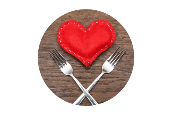 Red stitched heart between knife and fork. 