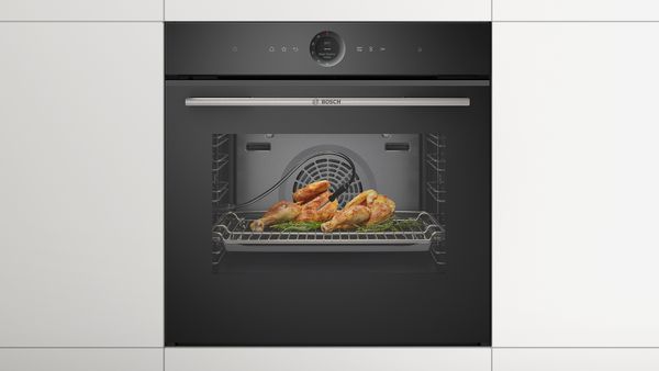 Nicely roasted chicken with a meat sensor in an oven.